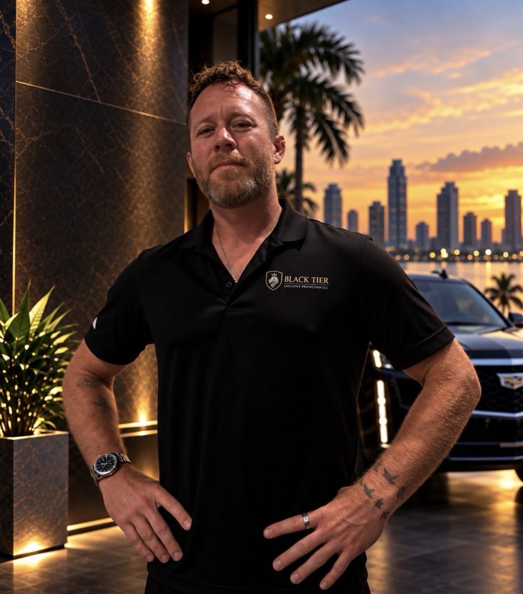 Nathan Waits in a Black Tier polo beside a black SUV at sunset